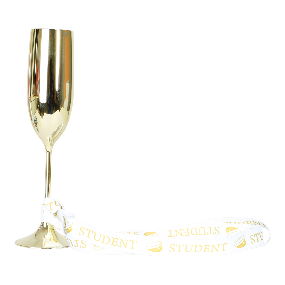guldfärgat champagneglas med utslaget vitt studentband