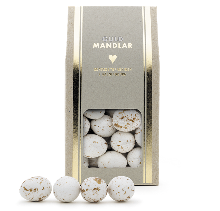 beige kartong med guldrand och fönster som visar vita mandlar med guldfläckar, guldmandel 150g
