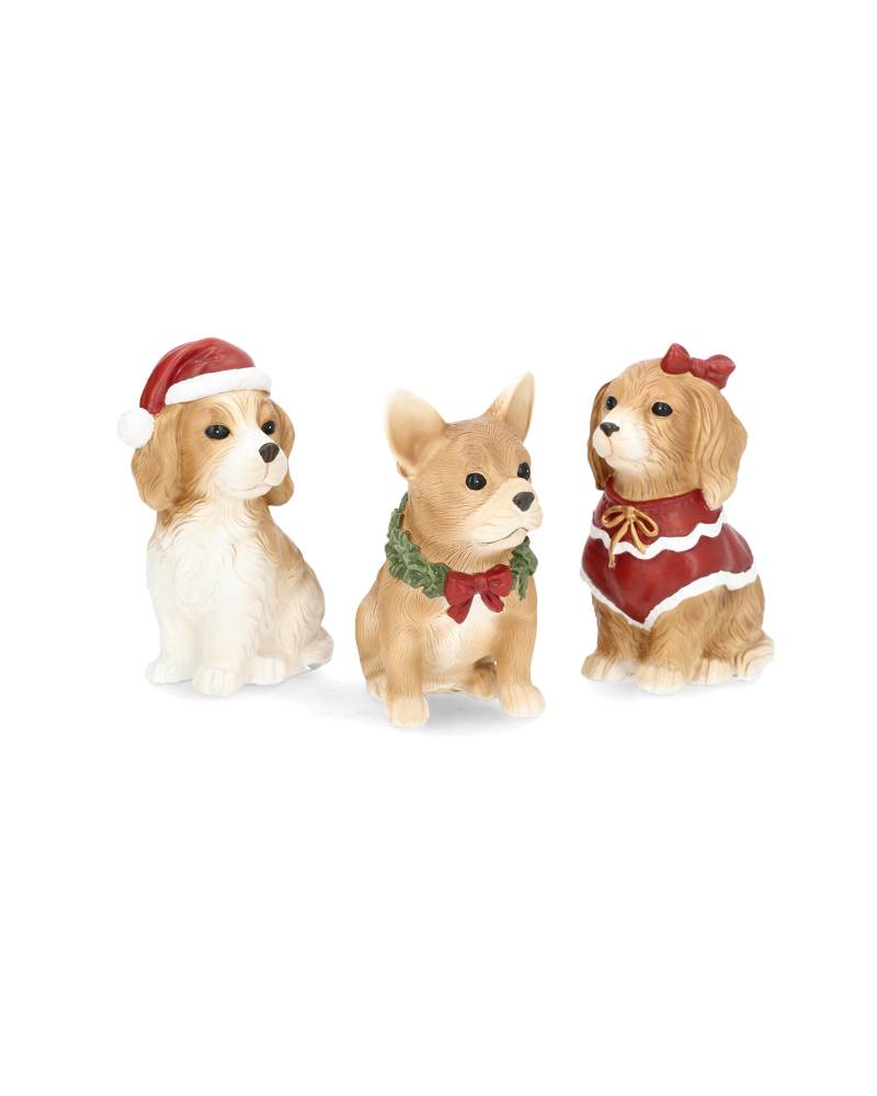 tre små hundfigurer på vit bakgrund, en hund med tomteluva och två andra hundar med juliga accessoarer